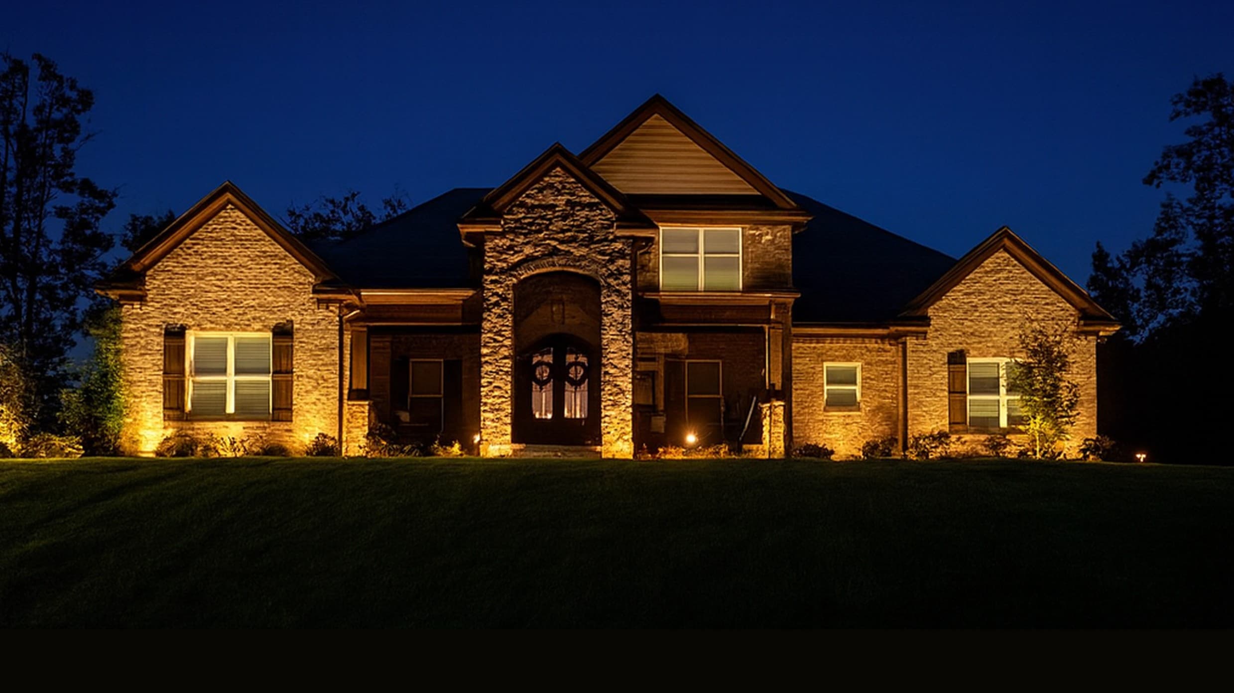 Beautifully lit home showcasing professional landscape lighting