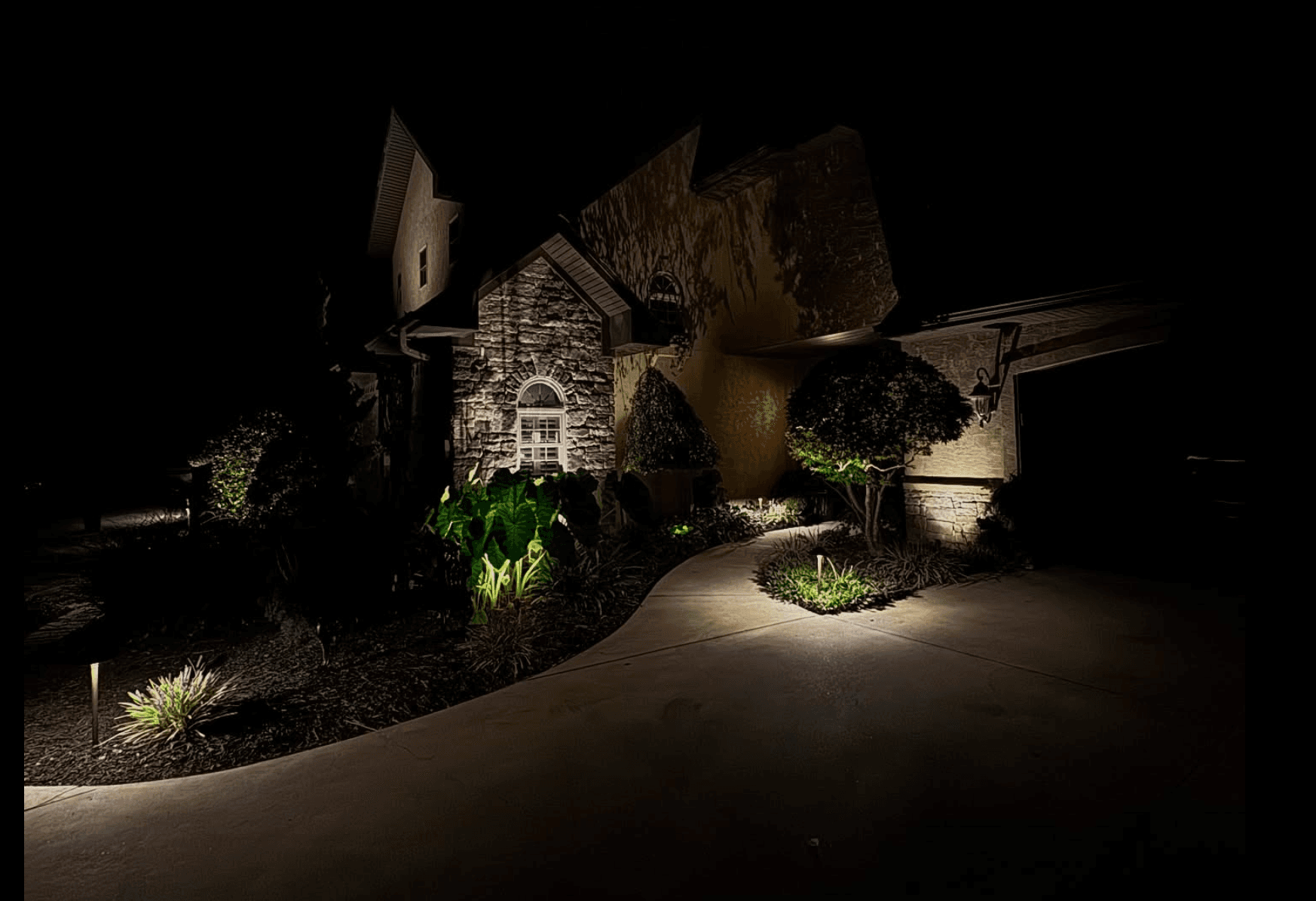 Stone Home Pathway Lighting Luxury stone home with dramatic pathway lighting
