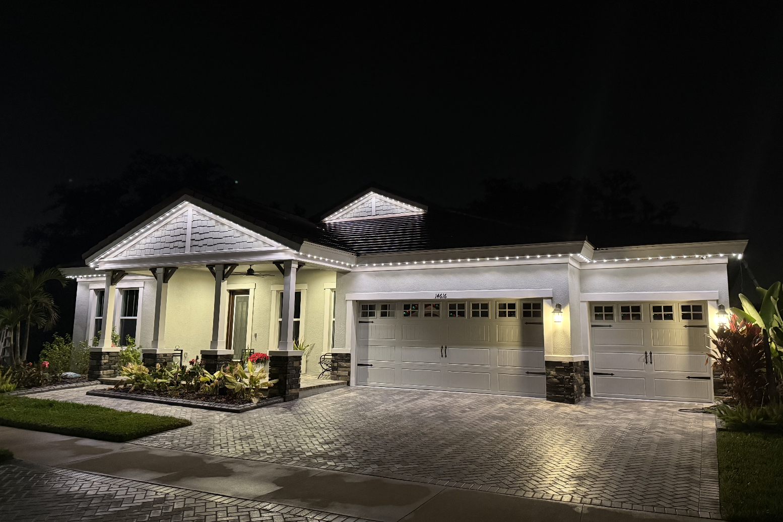 Clean white permanent lighting on Florida ranch style home