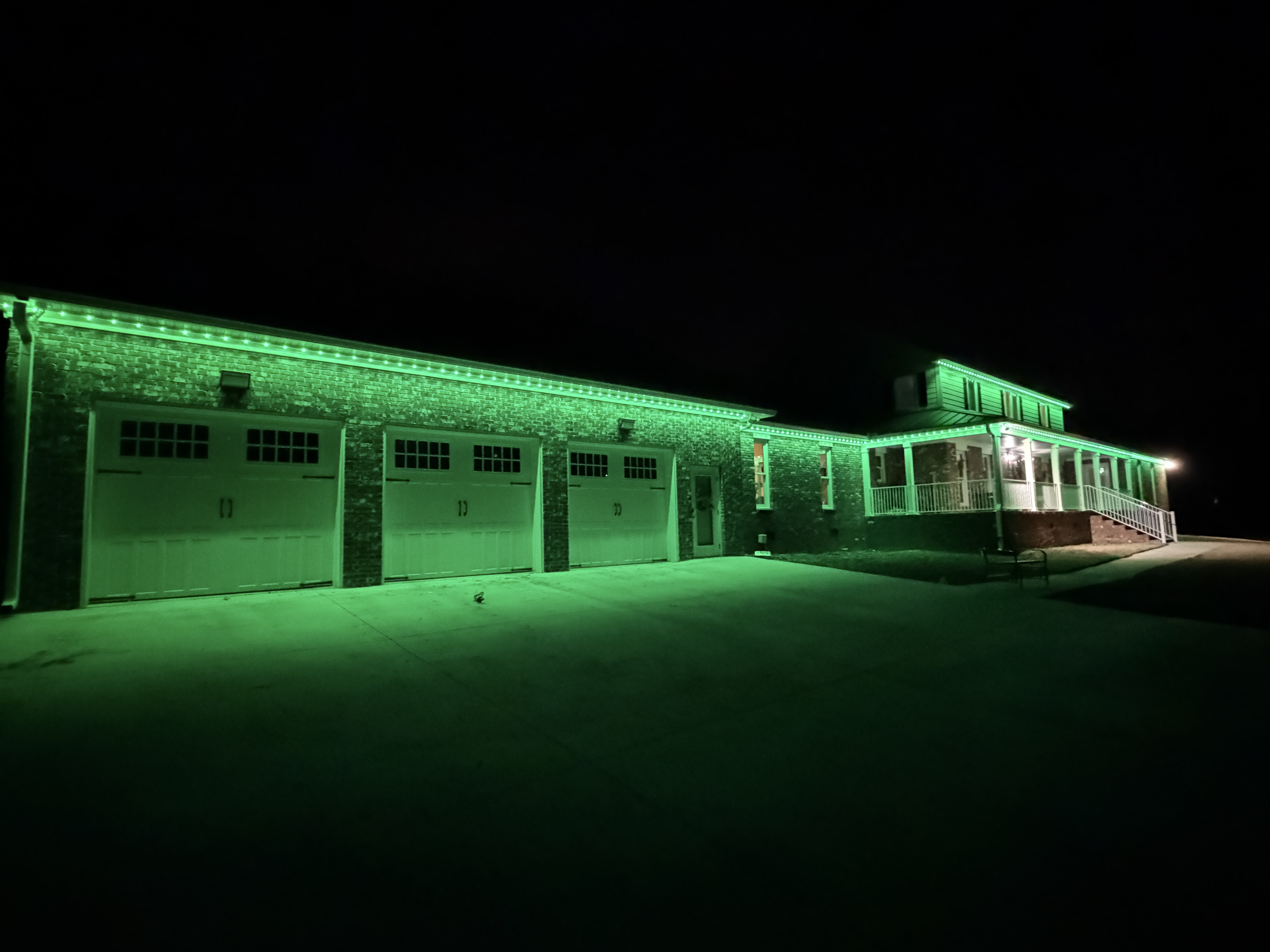 Green holiday lighting display on residential home